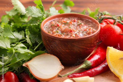 Traditional mexican red spicy sauce salsa with ingredients photo