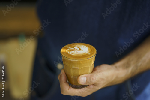 ฺBarista make coffee latte art with coffee machine in coffee shop cafe in vintage color tone