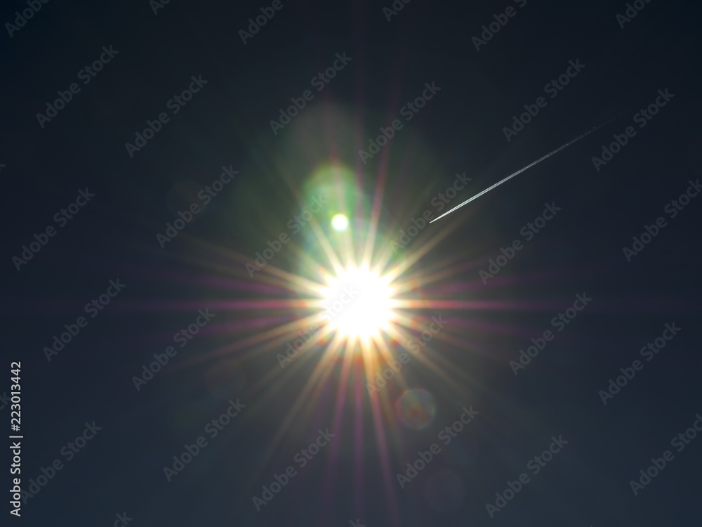 sun in space with airplane