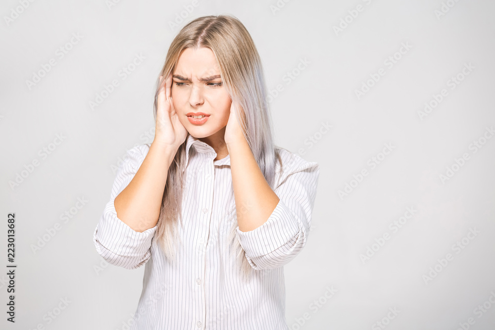 Portrait of beautiful young woman with bare shoulders touching her temples feeling stress, on white background Portrait of beautiful young woman with bare shoulders touching her temples feeling stress, on white background