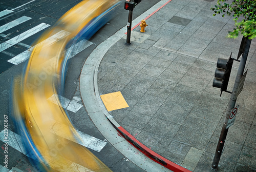  Multiple exposure of a taxi cab turning a downtown street corner as seen from above.