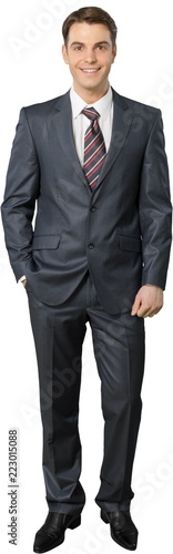Friendly Businessman Standing with Hand in Pocket - Isolated