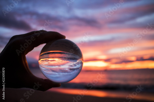 Bright Colorful Sunset over Ocean Captured in Glass Ball