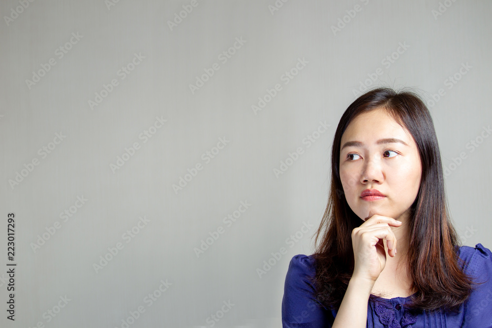 Young Asian women is thinking about something close up with copy space on left side. Young Asian women is thinking about something close up with copy space on left side.