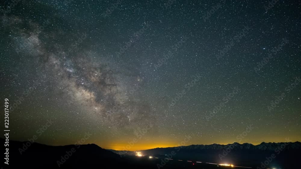 The stars and Milky Way move across the night sky. The stars and Milky Way move across the night sky.