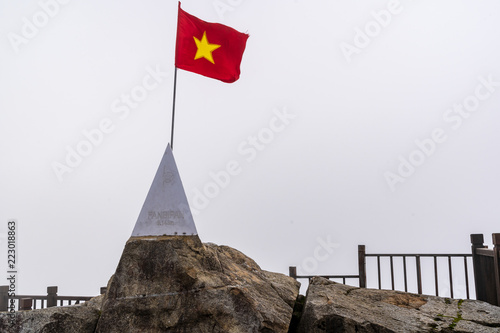 Peak of Fansipan and flag in the clouds on SAPA VIETNAM. Top spot in Indochina altitude 3,143m landmark in VIETNAM