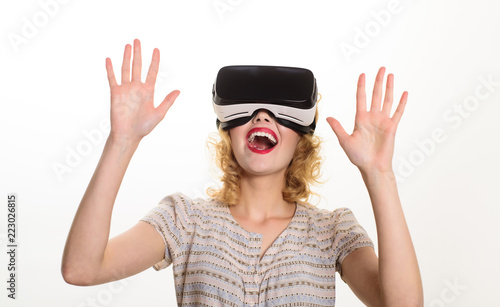 Smiling woman in virtual reality glasses. VR device. Woman with VR headset. Happy woman in virtual reality headset isolated on white background. Future. Future technology concept.