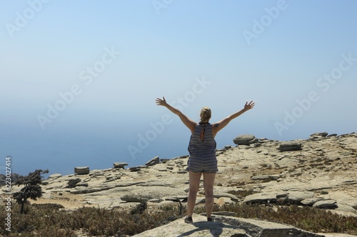 happy woman raising her arms to the sky 