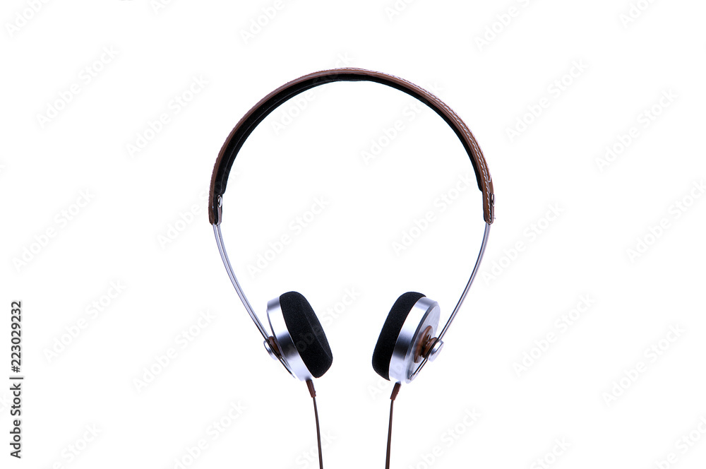 Silver headphones with cable isolated on white background. Silver headphones with cable isolated on white background.