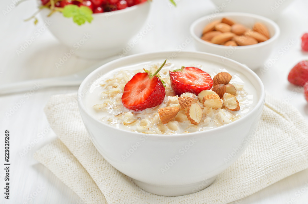 Oatmeal porridge with strawberry slices and nuts Oatmeal porridge with strawberry slices and nuts