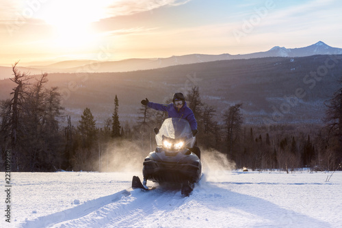 Athletes on a snowmobile.