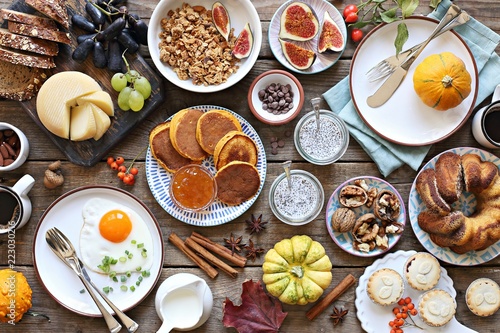 Thanksgiving Brunch. Autumn family breakfast or brunch set served on rustic wooden table. Overhead view, copy space