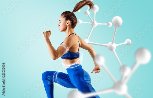 Sporty young woman runing and jumping near molecule chain.