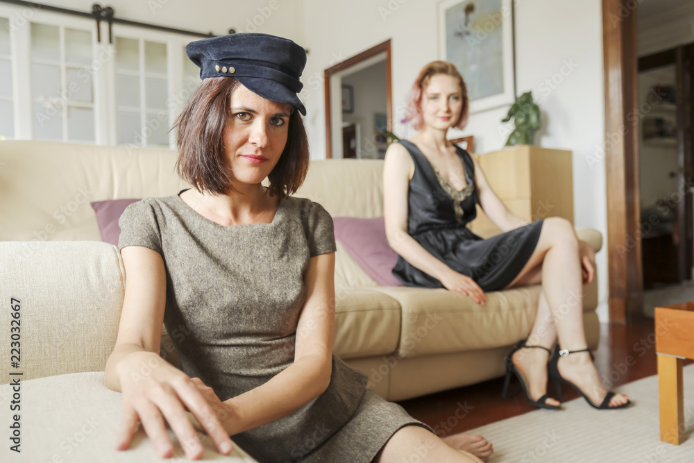 Obraz premium young beautiful ladies on the leather sofa