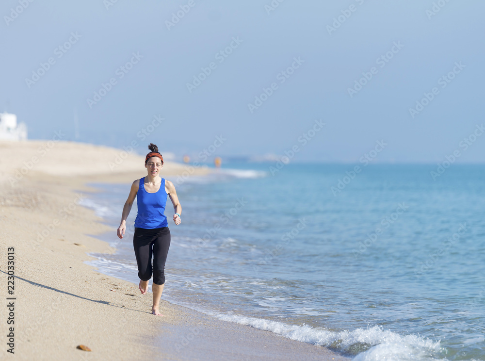 young fitness woman jogging at beach young fitness woman jogging at beach