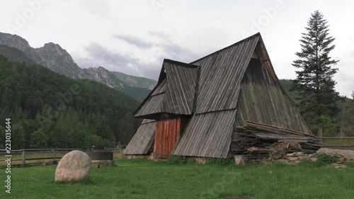 Poland,Zakopane, View of the highlander hut. In the background of mountains TATRY, Clouds. Trees and meadows. Sleeping knight and cross at Giewont. Sunrise. Panning camera, Pan, Closeup photo