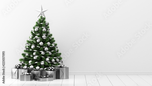 decorated christmas tree with gift boxes in white room
