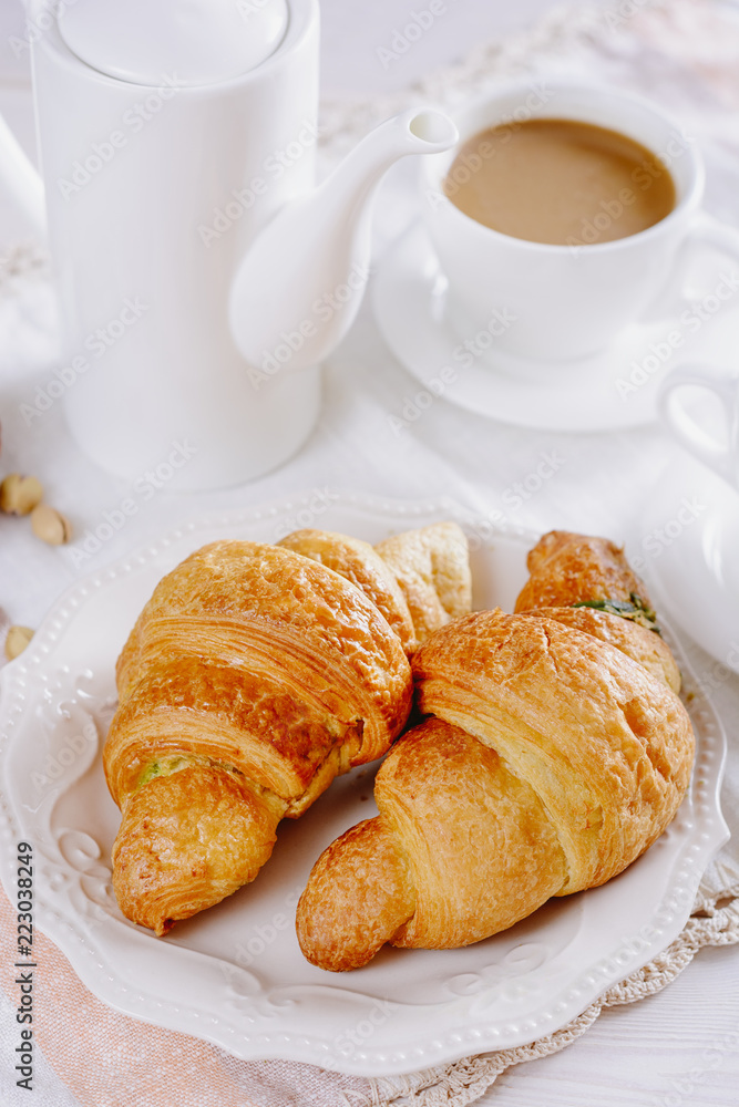 Fresh croissants for breakfast and coffee with milk