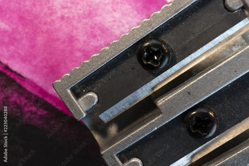 Macro, close-up of a pencil sharpener, pink and black abstract background Macro, close-up of a pencil sharpener, pink and black abstract background