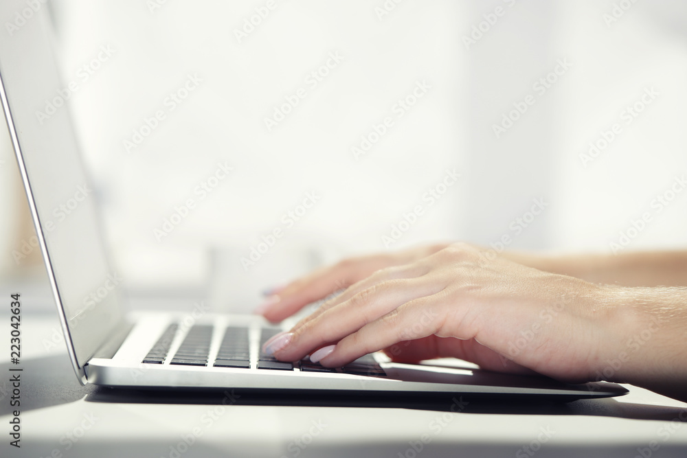 Woman typing on laptop at workplace Woman working in home office hand keyboard Woman typing on laptop at workplace Woman working in home office hand keyboard