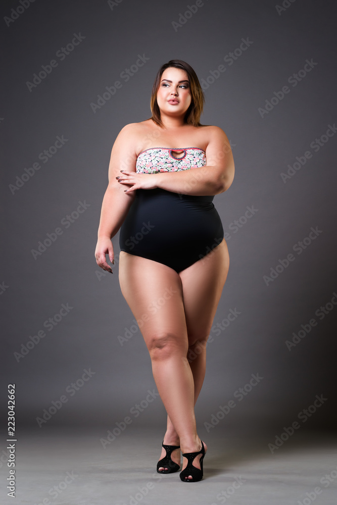 Foto Stock Plus size model in sexy swimsuit, fat woman on gray background,  overweight female body | Adobe Stock