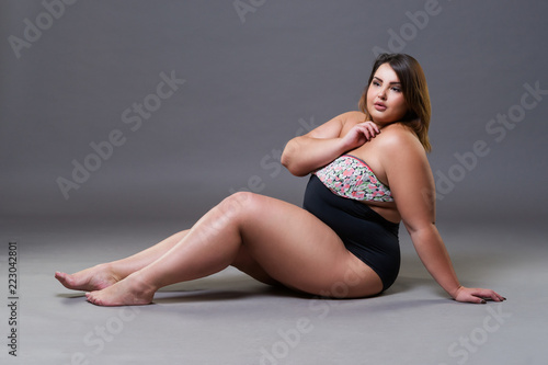 Canvas Print Plus size model in sexy swimsuit, fat woman on gray background, overweight femal