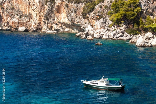 Fishing boat by the coast of Croatia. Fishing near the island of Hvar. Ship in the bay. Adriatic Sea Coast. Greetings from vacation. © martinfredy