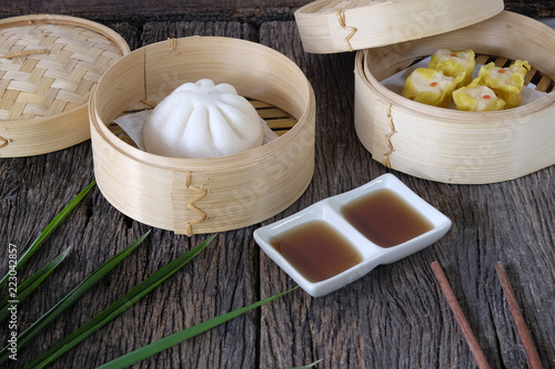 Hot buns dim sum on wooden table.