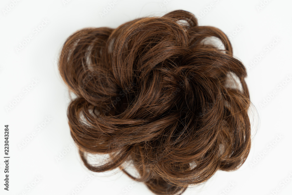 Messy bun of brown brunette hair, isolated on white background Messy bun of brown brunette hair, isolated on white background