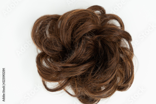 Messy bun of brown brunette hair, isolated on white background