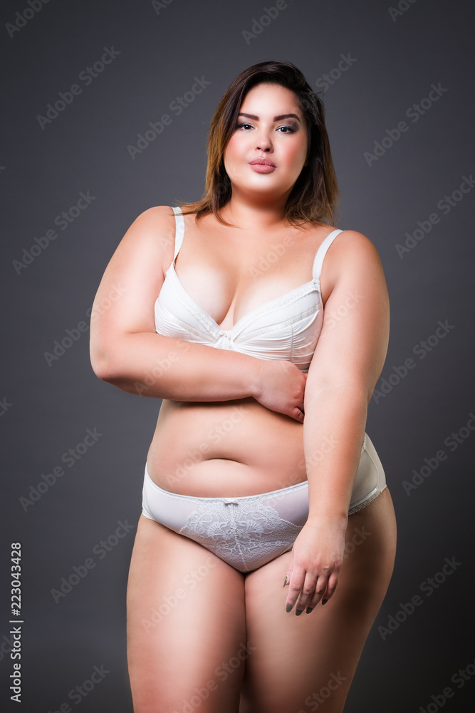 Plus size model in lingerie, fat woman on gray background, overweight  female body Stock Photo