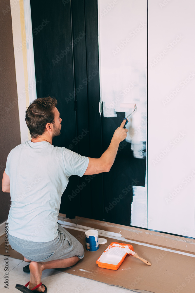 Man painting a wardrobe