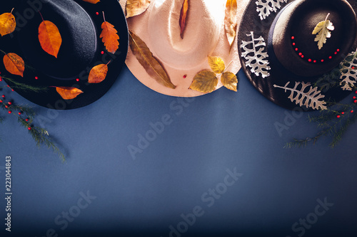 Autumn female outfit. Set of three cashmere hats decorated with fall leaves. Fashion and accessories concept. Copy space