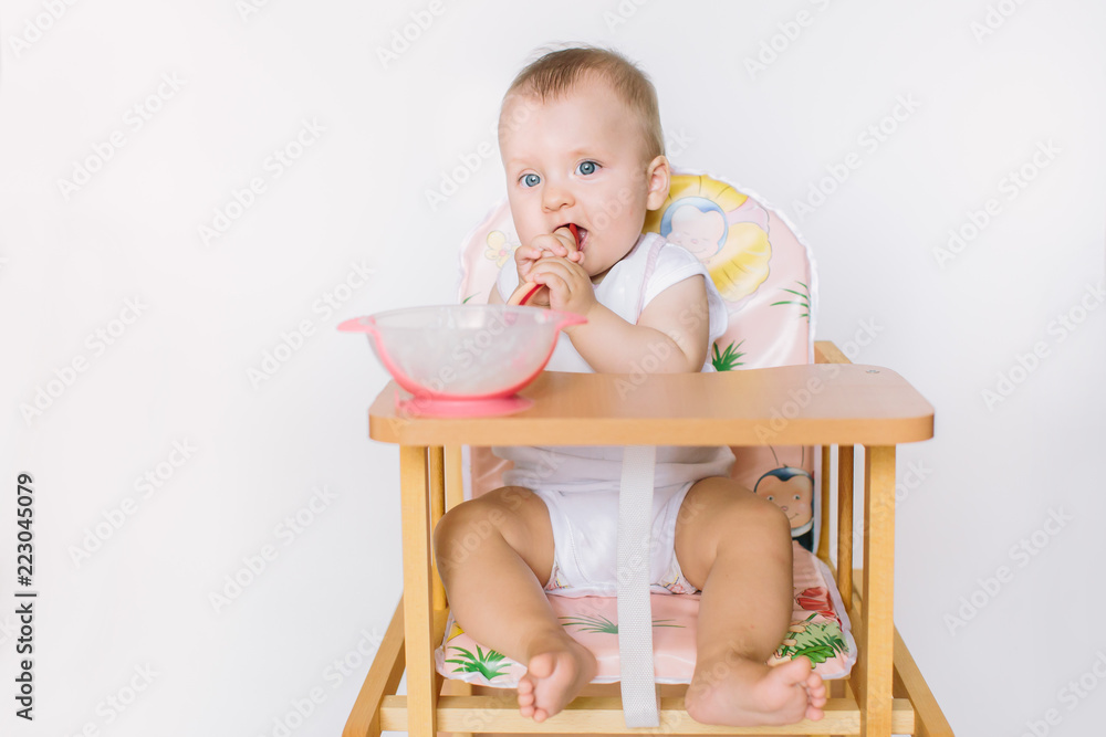 Baby girl with spoon on white background Baby girl with spoon on white background
