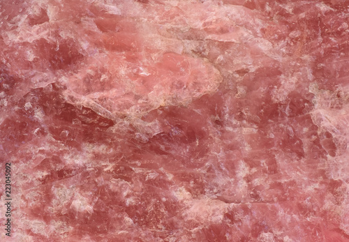 rose quartz texture - closeup of a rough rose quartz stone surface structure for backgrounds photo