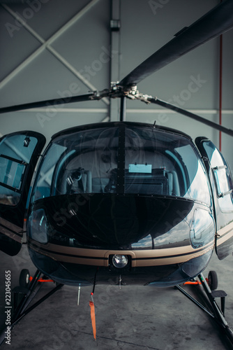 Small helicopter in hangar, private airline copter