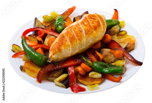 Top view  of tasty baked different vegetables with chicken fillet photo