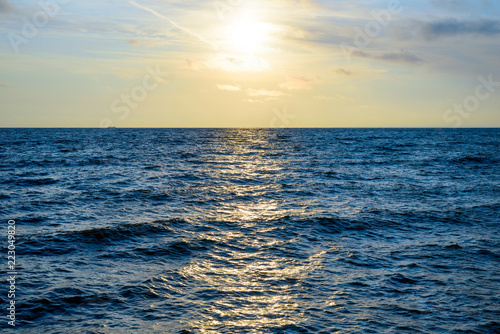 Minimalistic landscape of sunrise over the sea with waves