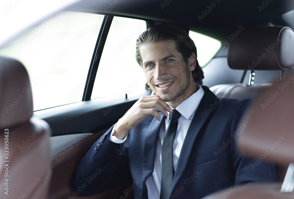 successful man sitting in the car
