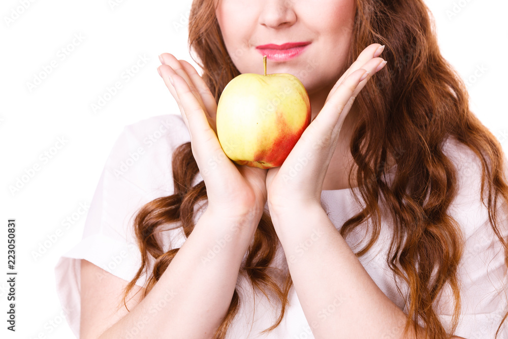 Woman holds apple fruit close to face, isolated Woman holds apple fruit close to face, isolated