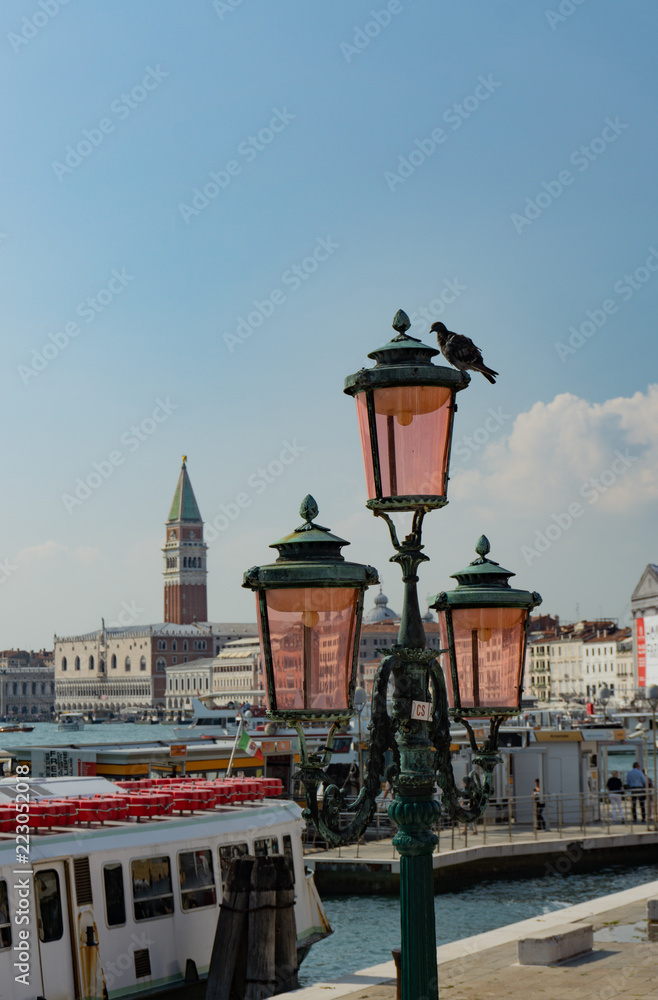 View of piazza san marco and grand canal behind a typical venetian light pole, Venice, Veneto, Italy