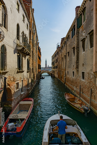 Narrow canal with green wather in Venice  Veneto  Italy
