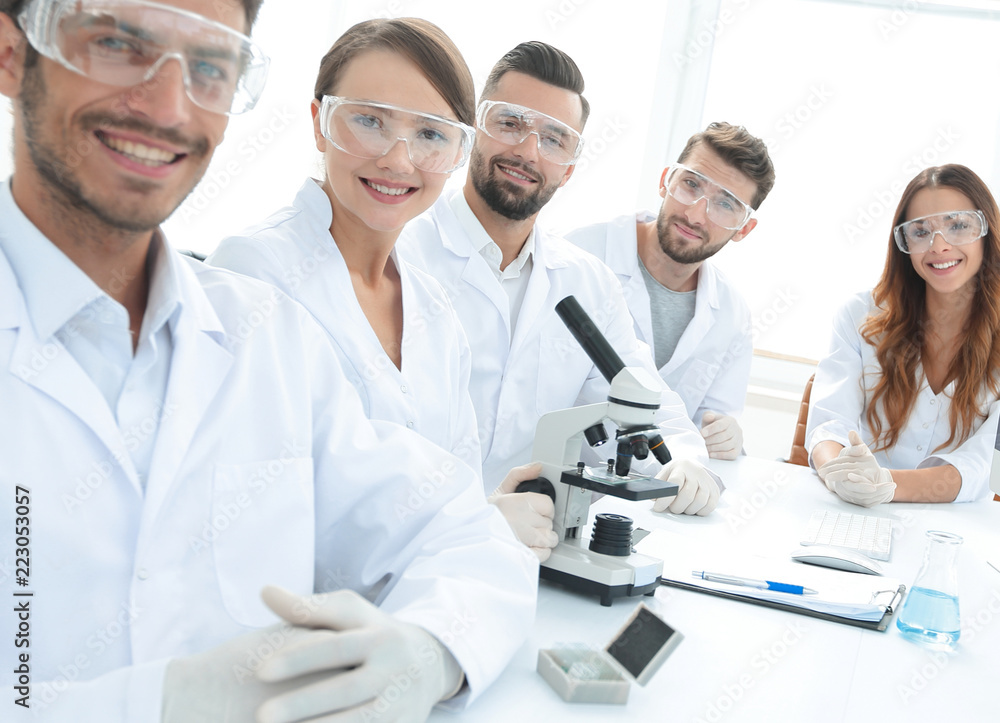 Male scientist and the team in the lab. Male scientist and the team in the lab.