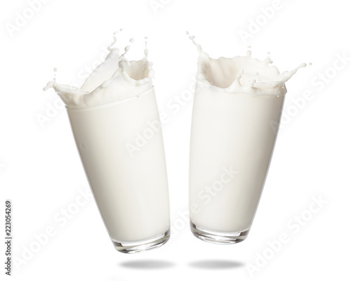 Couple milk splashing out of glass isolated on white background.