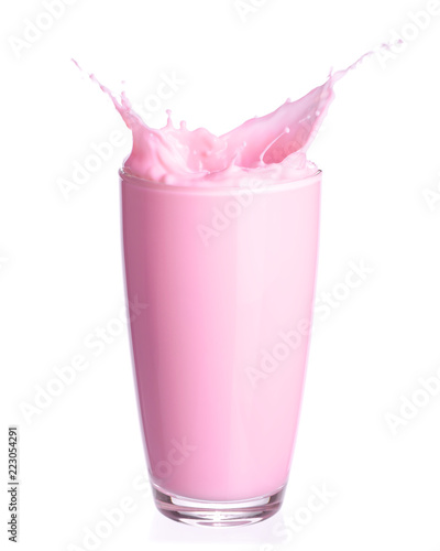 Strawberry milk splash out of glass isolated on white background.