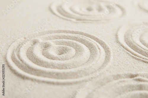 Zen drawing on white sand. Concept of harmony, balance and meditation, spa, massage, relax