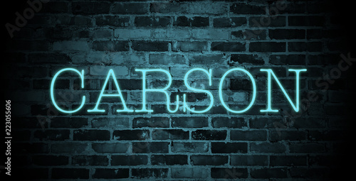 first name carson in blue neon on brick wall