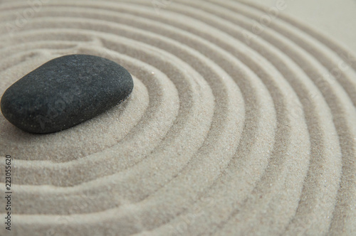 Pyramids of gray zen stones on the sand with wave drawings. Concept of harmony  balance and meditation  spa  massage  relax