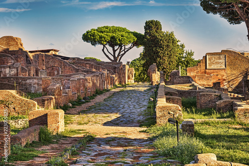 Archaeological Roman ruin street view in Ostia antica, a beautiful travel archaeology destination with well preserved ancient Rome ruins in ancient Ostia in Rome - Italy photo
