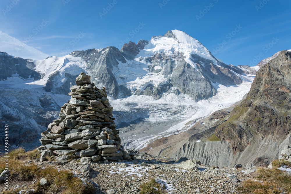 Pile of balancing stones in the mountains with a glacier in the background